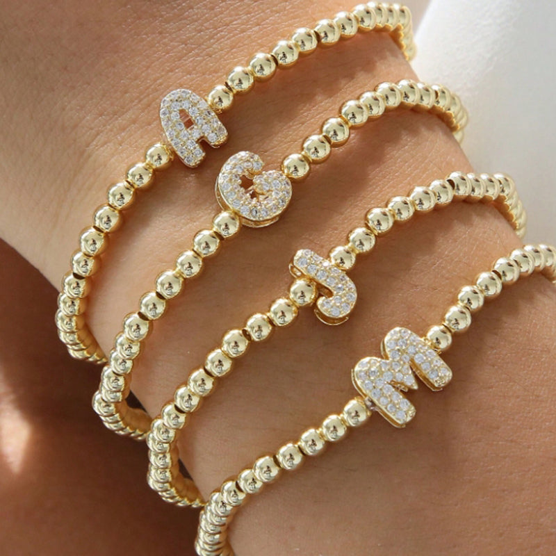 A Copper Plated Gold And Diamond Beaded 26 Letter Bracelet