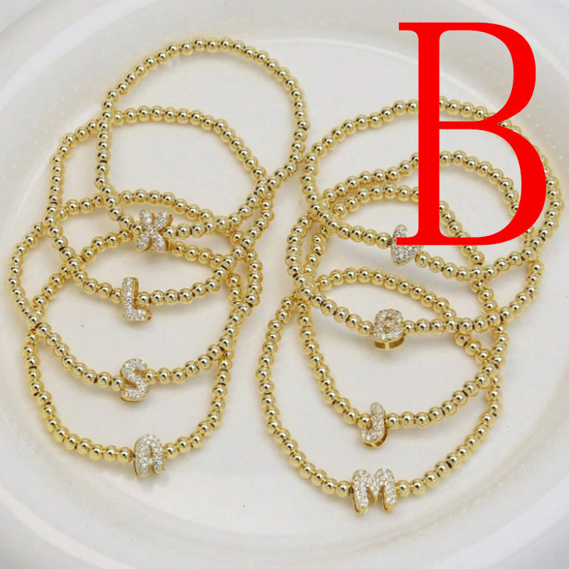 A Copper Plated Gold And Diamond Beaded 26 Letter Bracelet