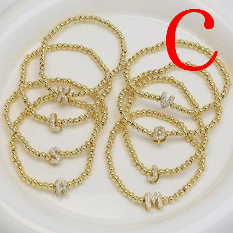 A Copper Plated Gold And Diamond Beaded 26 Letter Bracelet